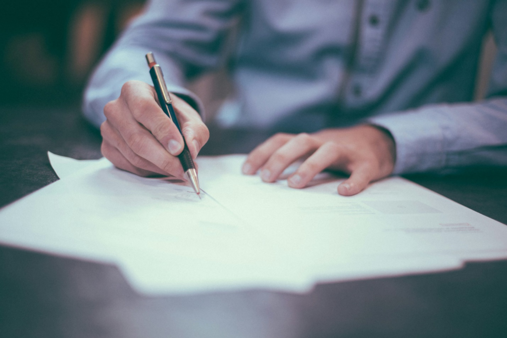 Man signing on a paper