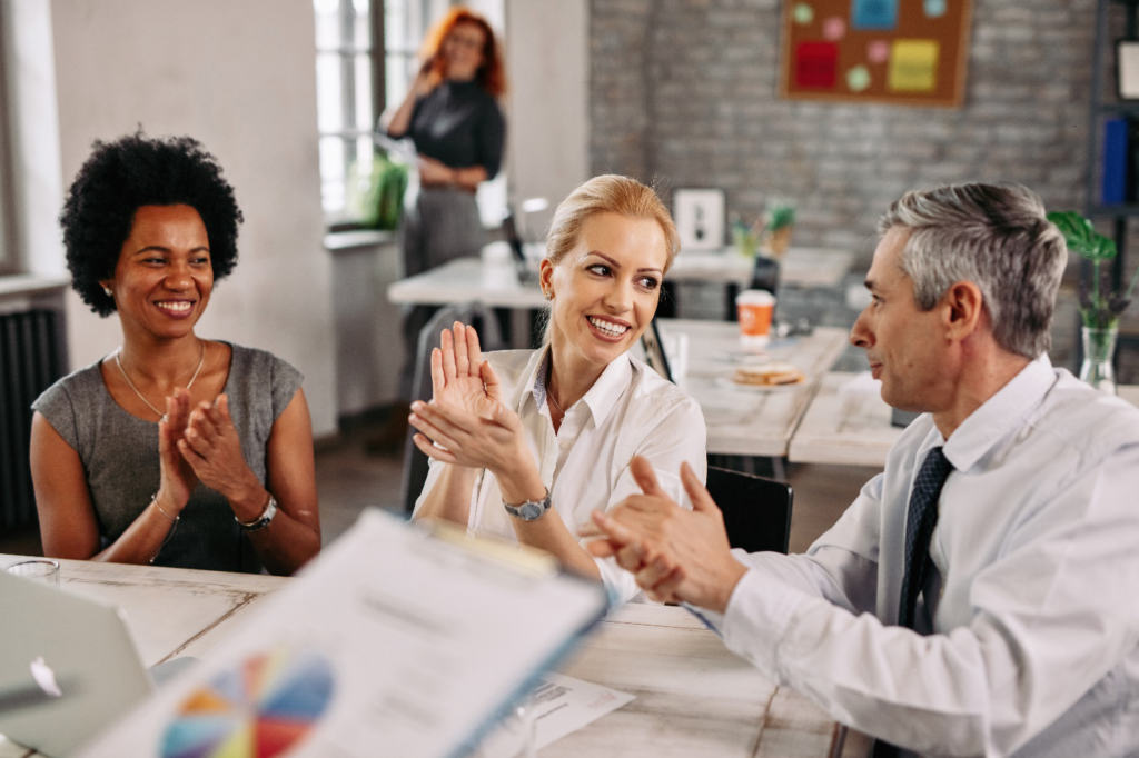 Three people having a discussion at a workplace