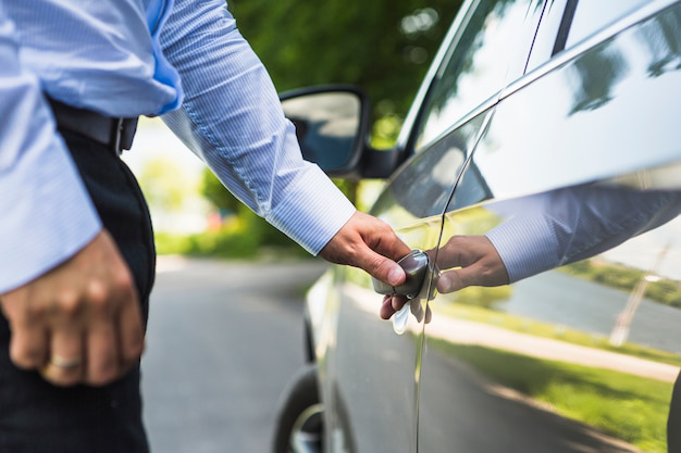 a man standing next to a car