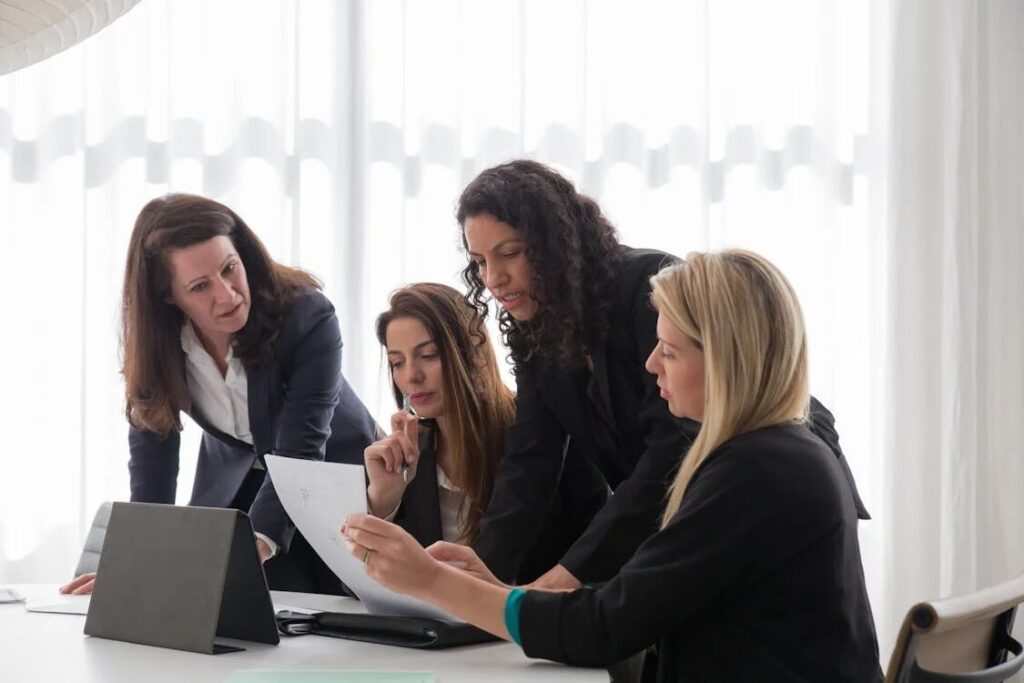 a group of women going over a document