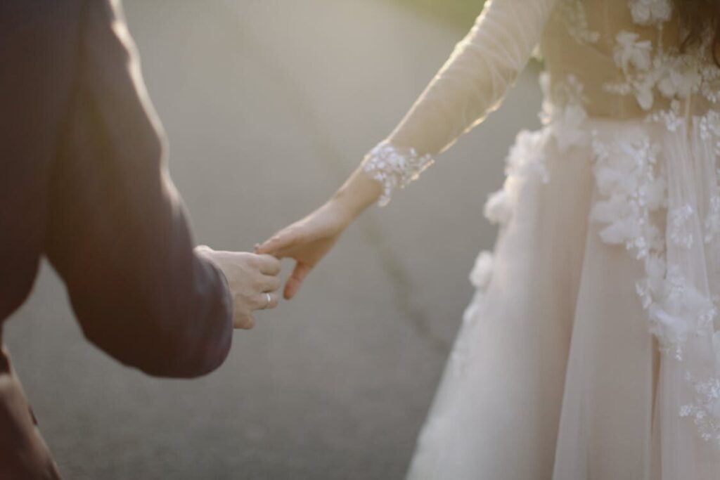 newlyweds holding hands.