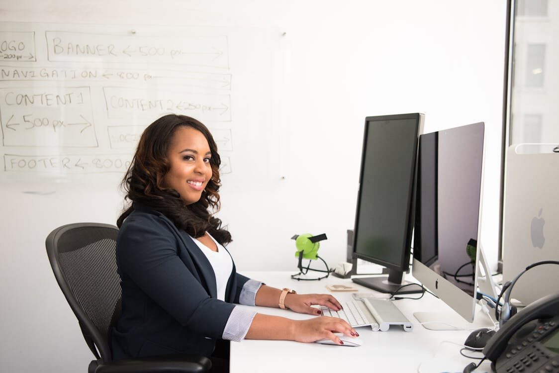 a woman typing at her desk